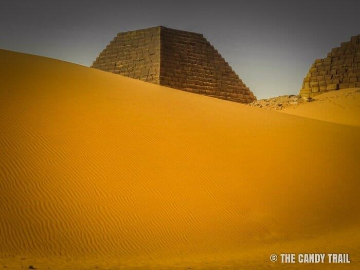 Sand dunes creeping up upon the Sudanese pyramids of Meroe.