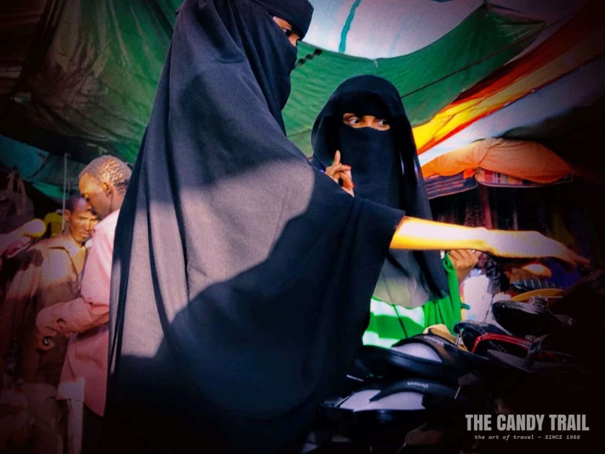 Somali Muslim women checking out shoes in Hargeisa market.