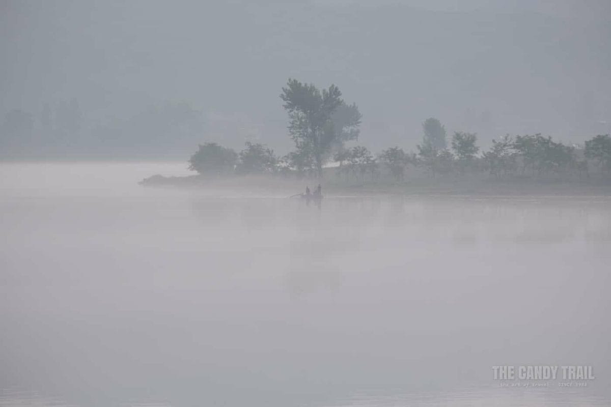 Fishermen In Boat On Yalu River North Korea Side
