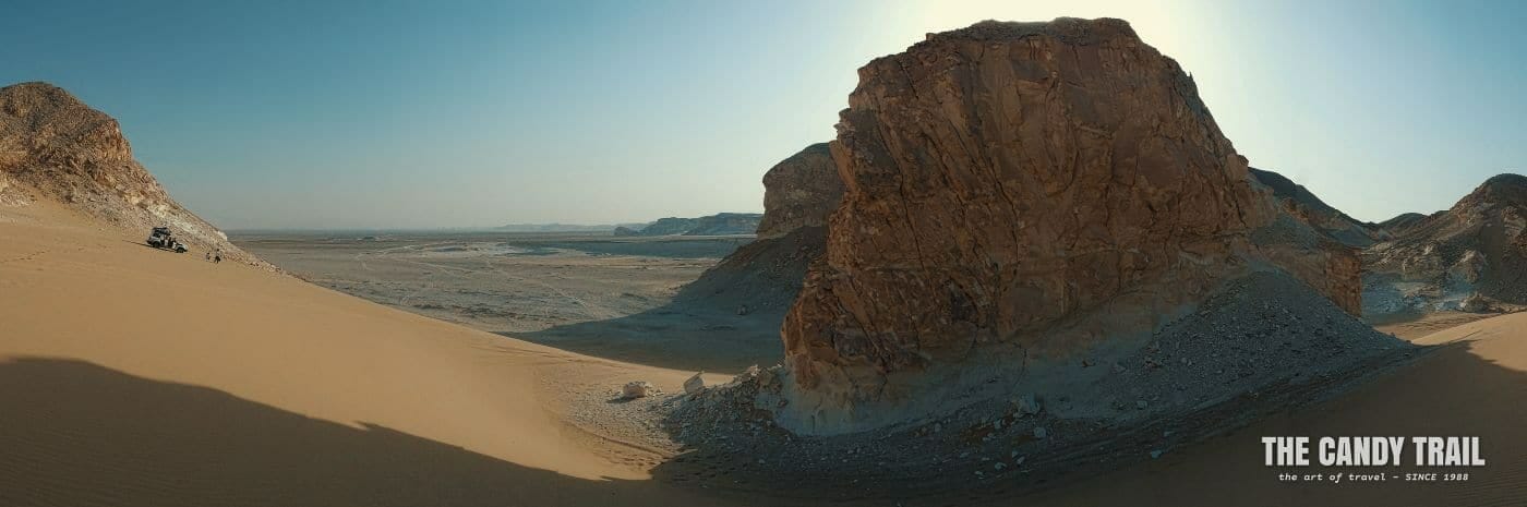 4WD vehicle in dunes amid rock hills on white desert tour in egypt