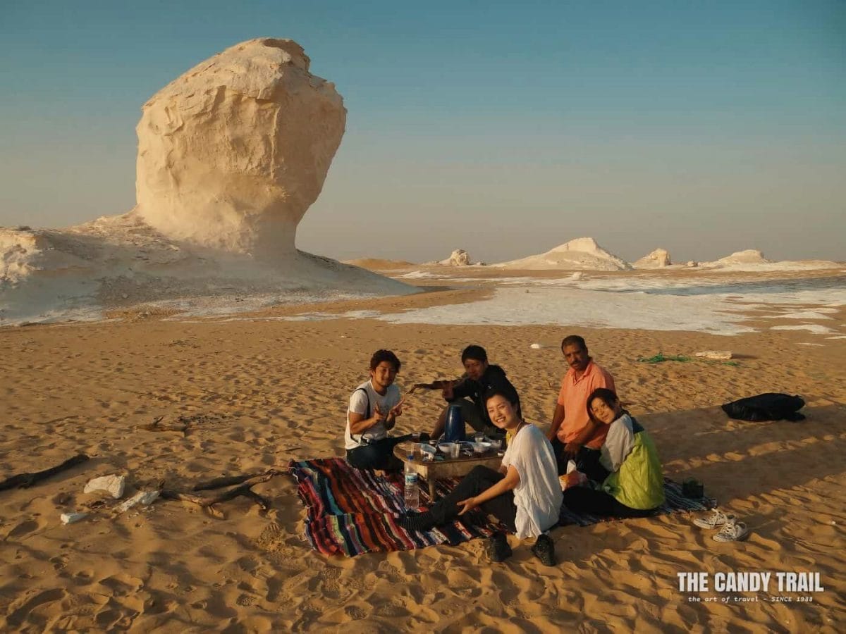 backpackers tour group camped in white desert in egypt