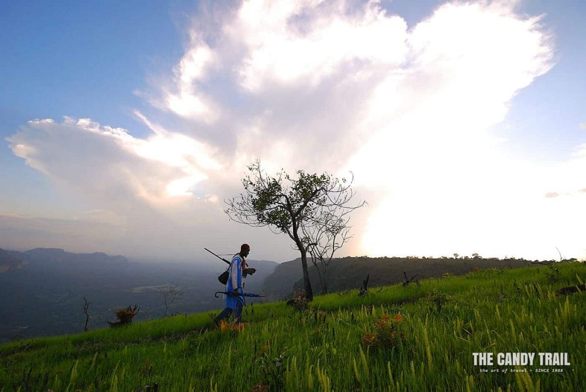 man above canyon amid fouta djallon highlands in guinea
