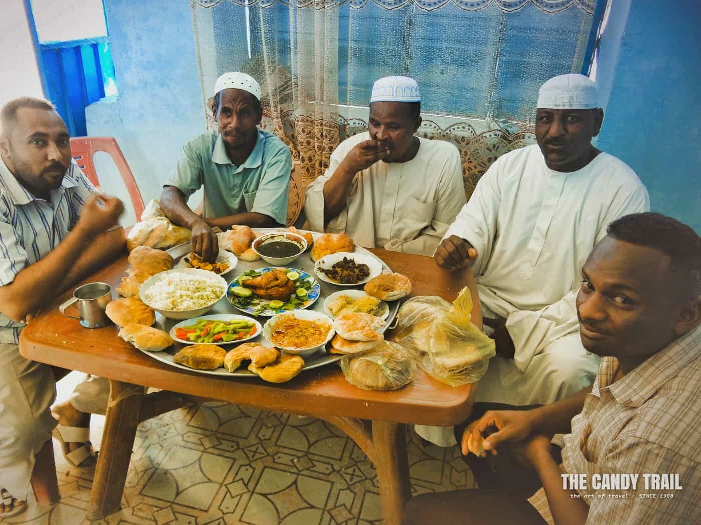 men at wedding reception meal in  dongola sudan