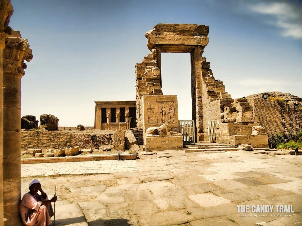 Site guardian shading at the Temple of Hathor at Dendera at searing summer's day