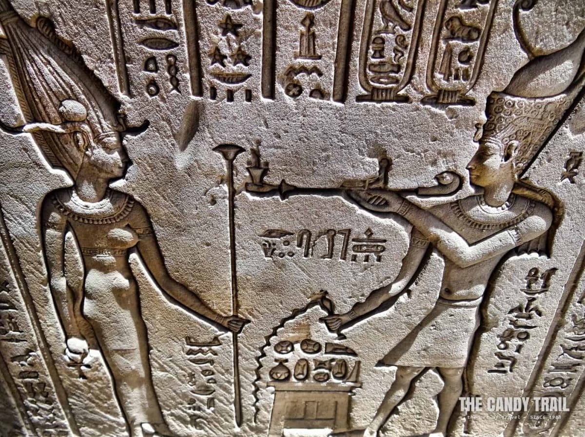 pharaoh with pipe sculpture on outer water of Hathor temple in Egypt
