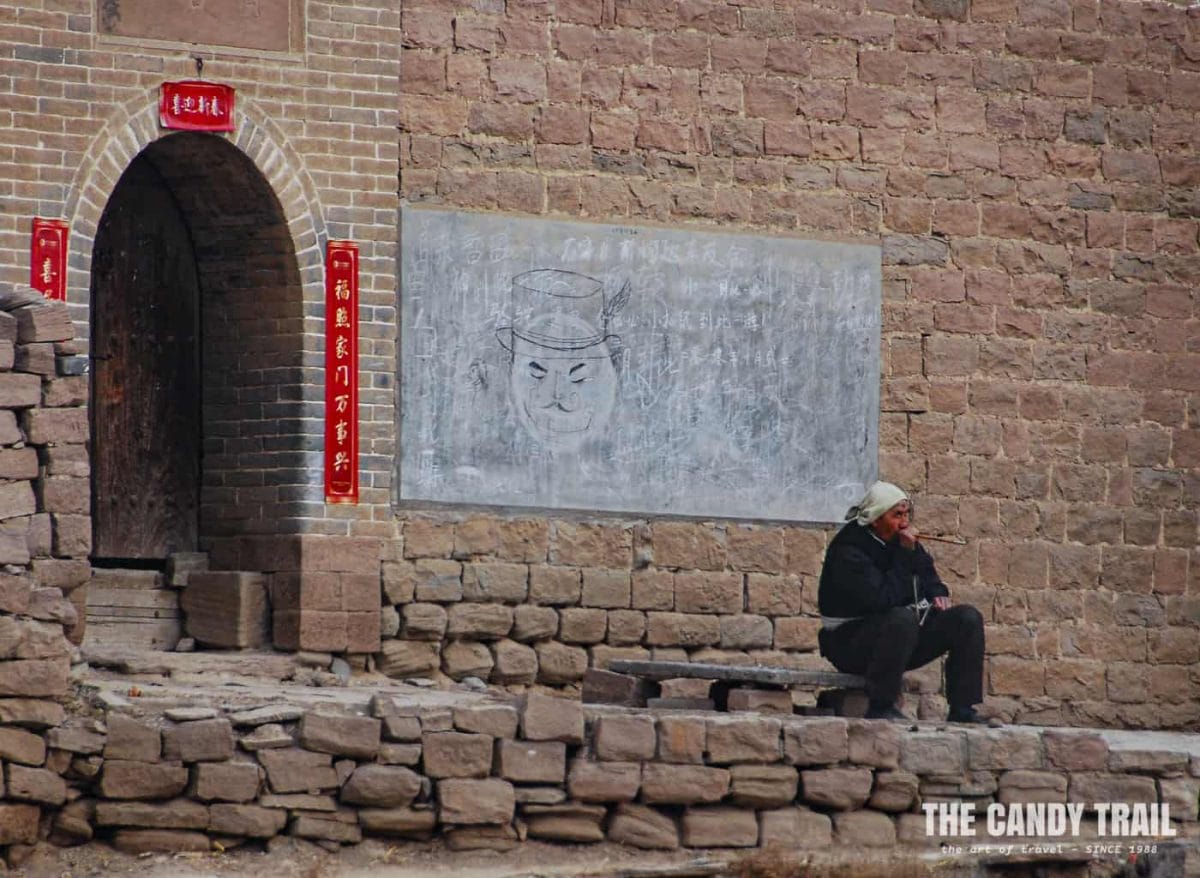 man smoking pipe lijiashan village china