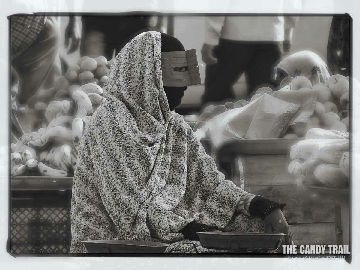 masked women vendor minab market iran