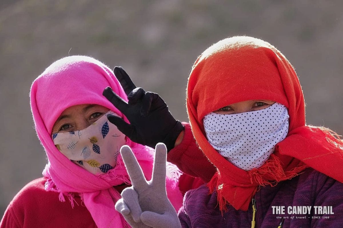 scarved Yugur nomadic women posing for photo