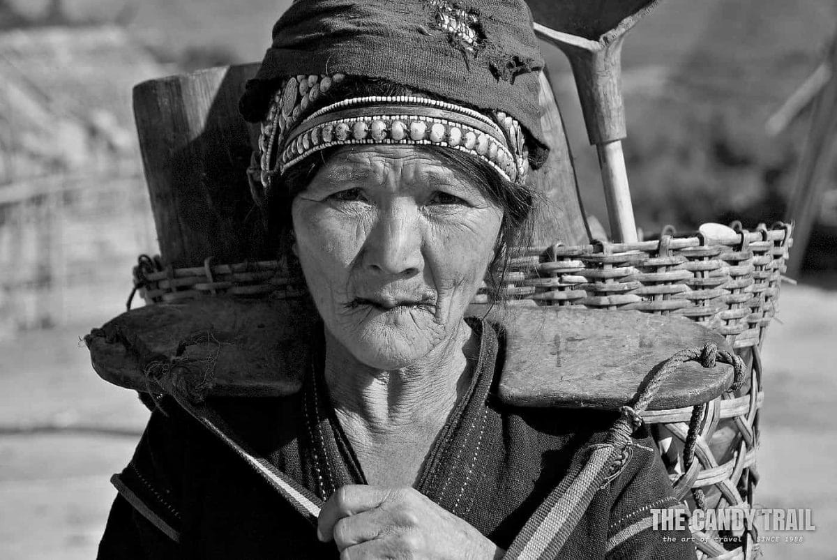 Portrait of elderly Akha tribal woman with basket
