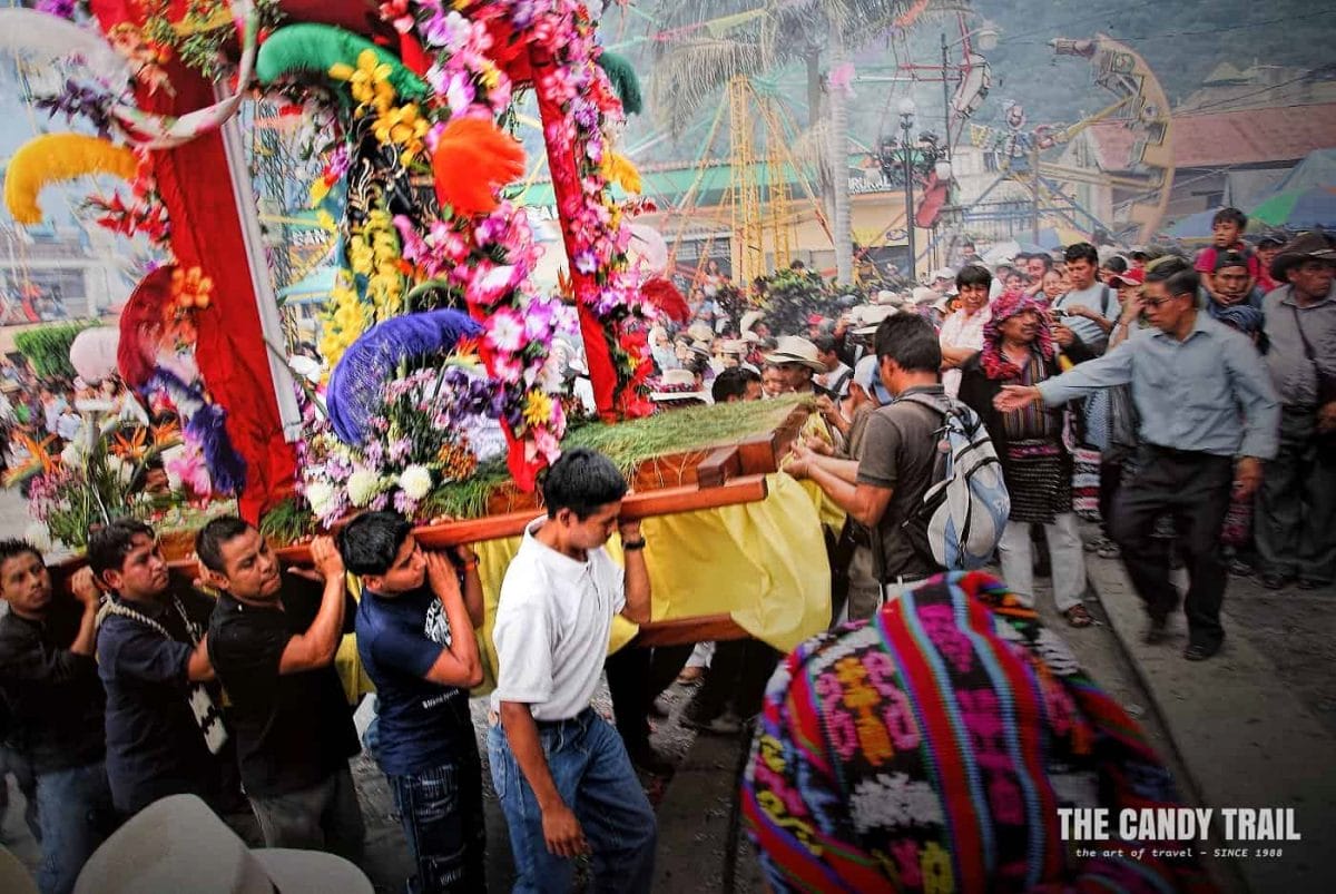 San Francisco de Asis statue being carried into church by Mayan men