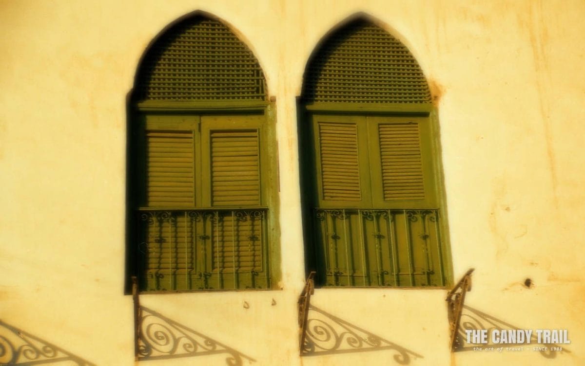 Windows in a colonial building in Massawa at sunset.