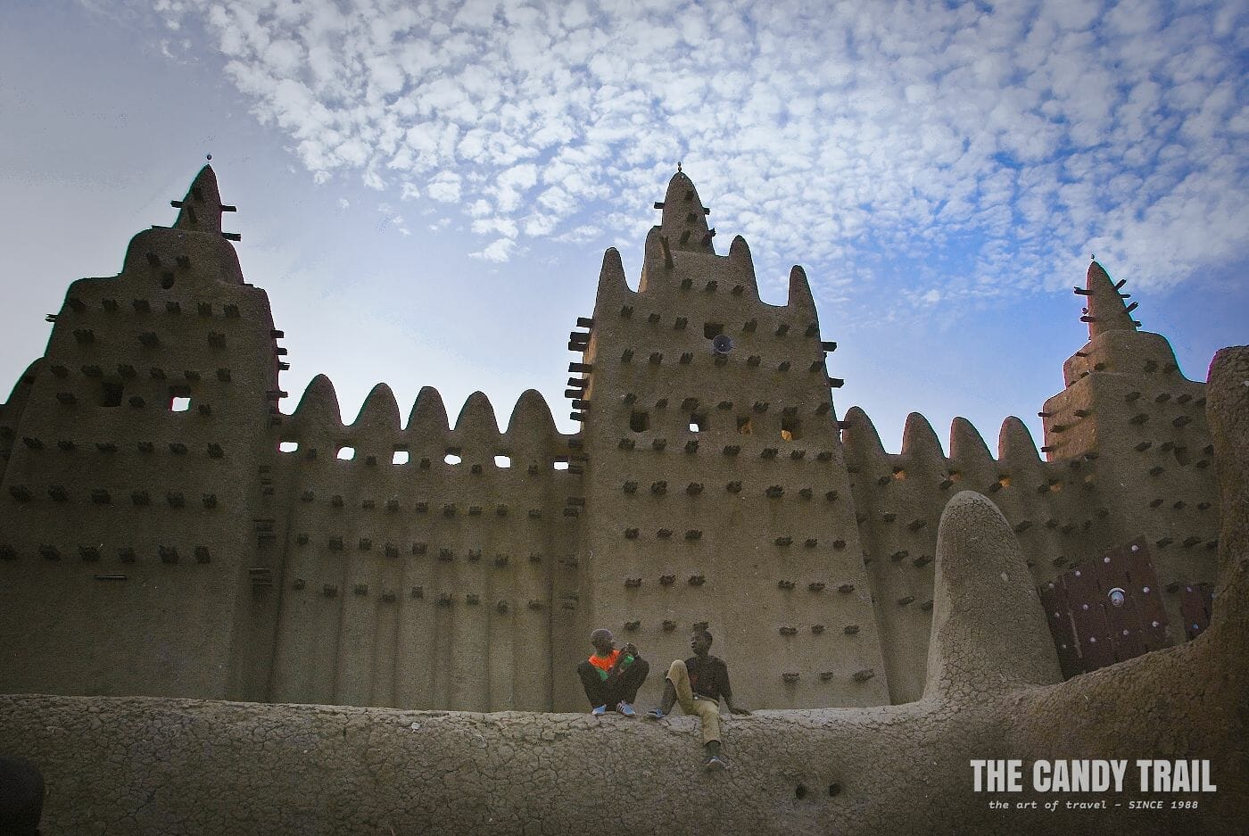 Boys chatting below the walls of the Great Mosque of Djenne.