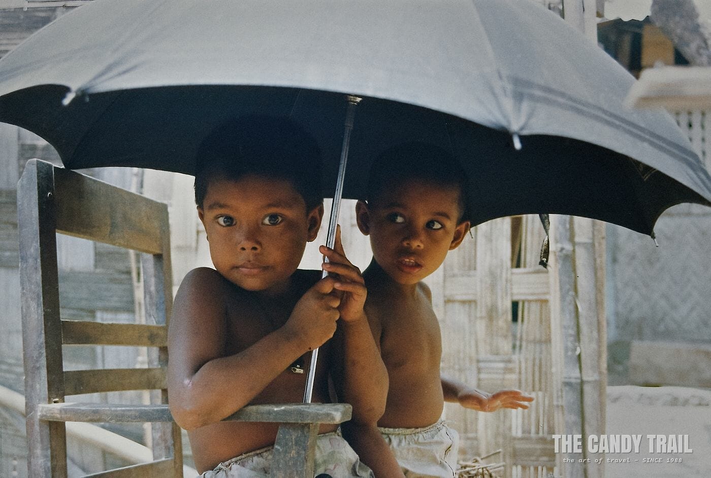 Boys shelter under an umbrella in Bangladesh, 1991.