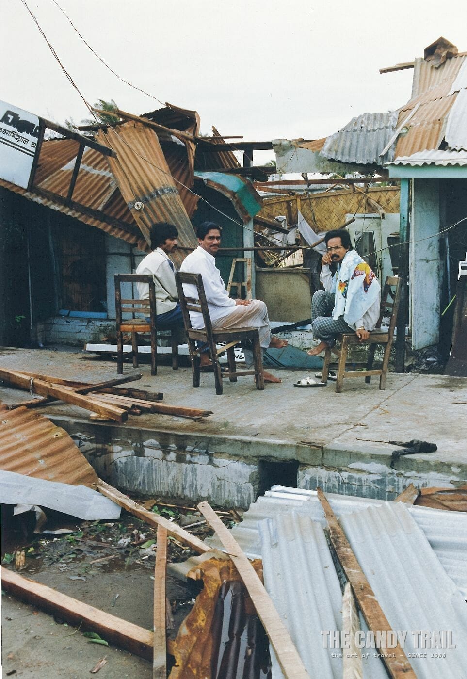 Shopkeepers outside their destroyed shops the morning after the cyclone swept Cox's Bazar in Bangladesh, 1991.