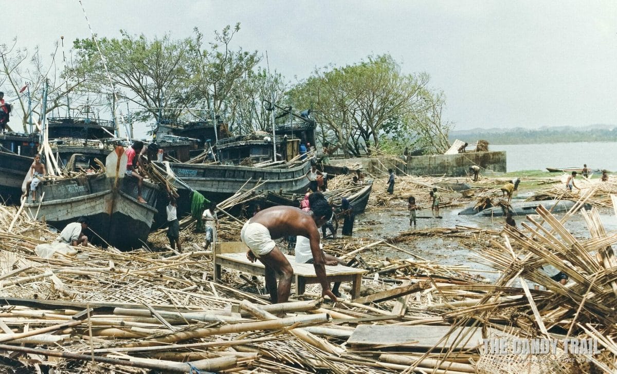 he day after the cyclone - boats shoved ashore as localsearch for belongings in Cox's Bazaar, Bangladesh in 1991.